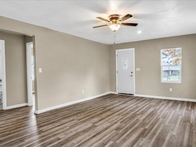 interior space with ceiling fan and dark hardwood / wood-style floors