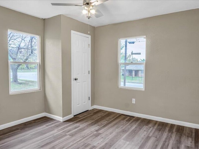 spare room featuring ceiling fan and light wood-type flooring