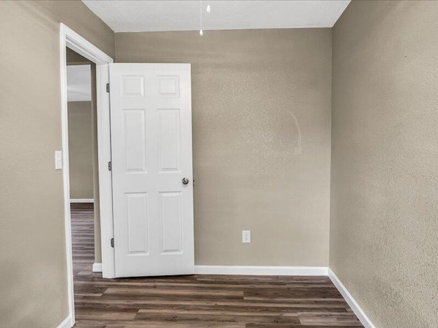 empty room with dark wood-type flooring