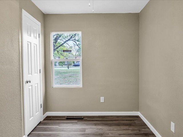 unfurnished room featuring dark hardwood / wood-style floors