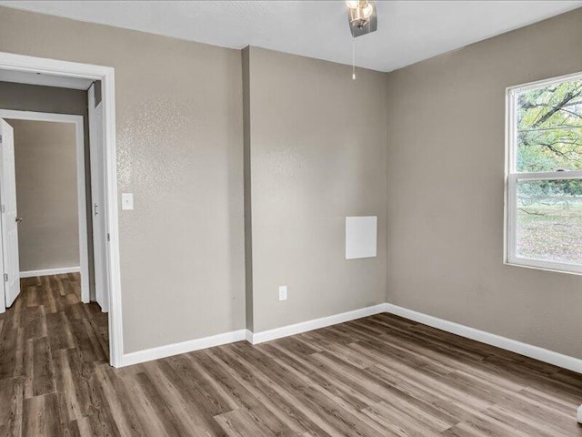 empty room with dark wood-type flooring