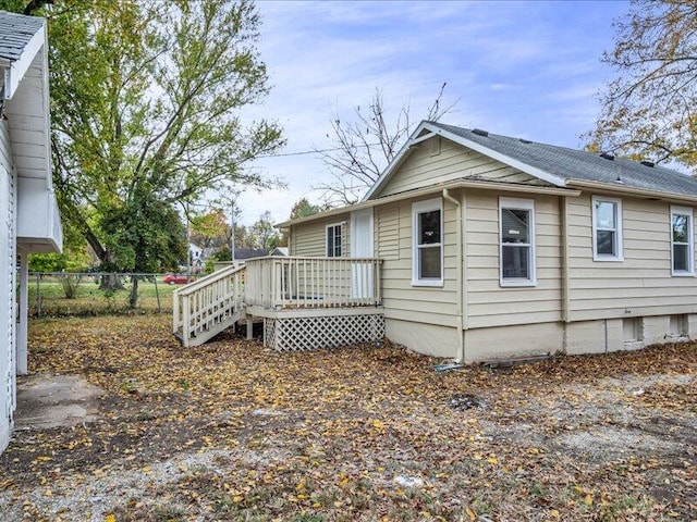 back of house featuring a wooden deck