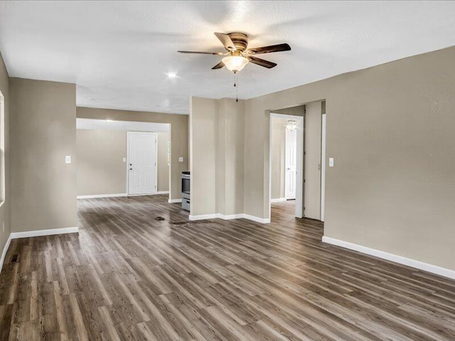 unfurnished room with ceiling fan and dark wood-type flooring