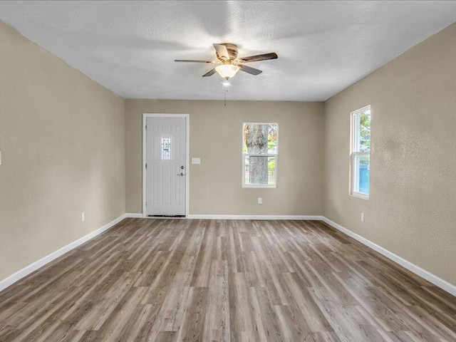 interior space with ceiling fan and hardwood / wood-style floors