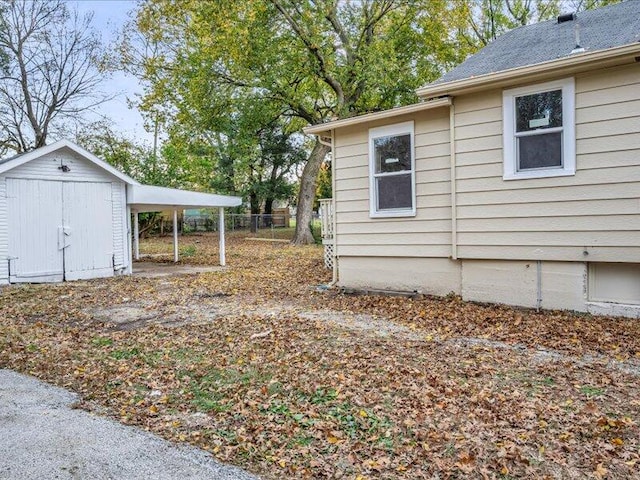 view of side of property with a shed and a carport