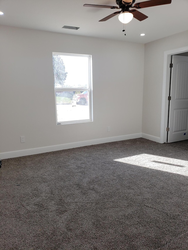 carpeted empty room featuring ceiling fan