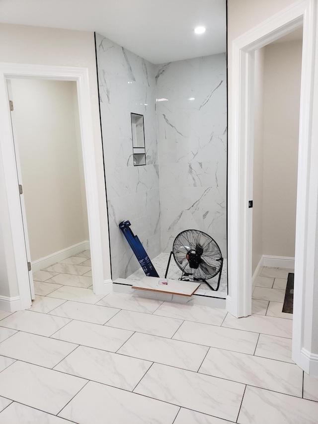 bathroom with a tile shower