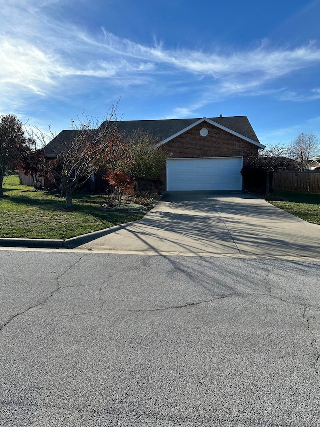 view of front of property featuring a front yard and a garage