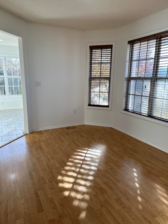 unfurnished room featuring wood-type flooring