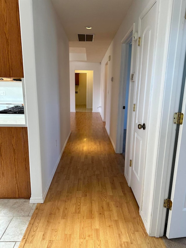 hall with light wood-type flooring