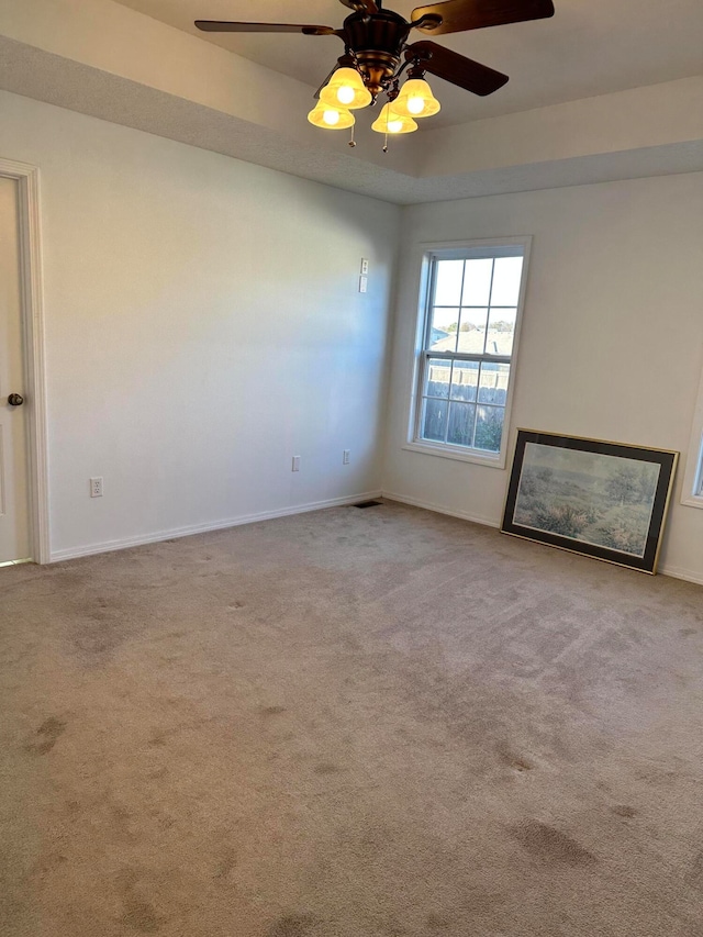 unfurnished living room featuring ceiling fan and light colored carpet