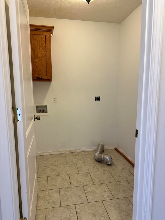 clothes washing area with cabinets, electric dryer hookup, hookup for a washing machine, a textured ceiling, and light tile patterned floors