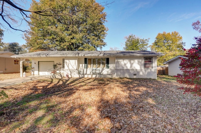 ranch-style home with a porch and a garage