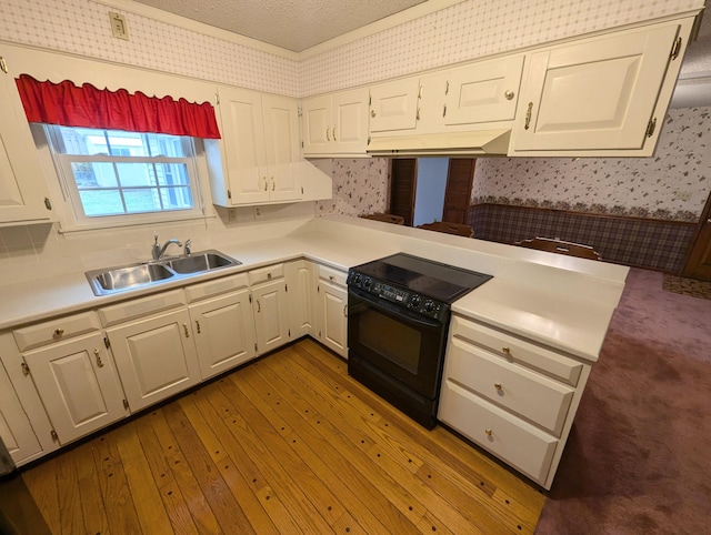 kitchen with white cabinets, sink, black electric range, dark hardwood / wood-style floors, and a textured ceiling