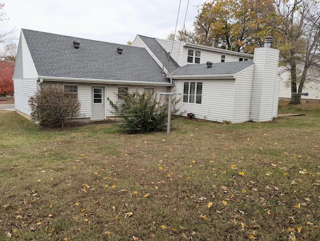 rear view of house with a lawn