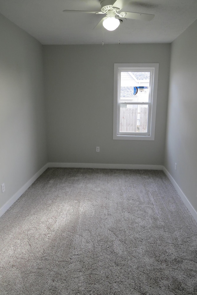 empty room with ceiling fan and carpet floors