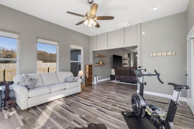 workout room with hardwood / wood-style floors and ceiling fan