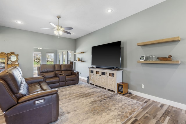 living room featuring wood-type flooring and ceiling fan