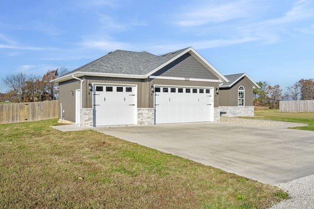 view of front of house featuring a garage and a front lawn