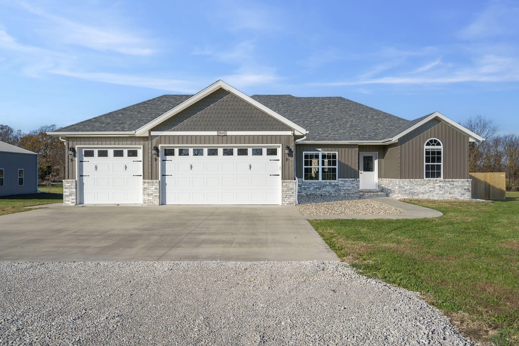 view of front of property featuring a garage and a front lawn