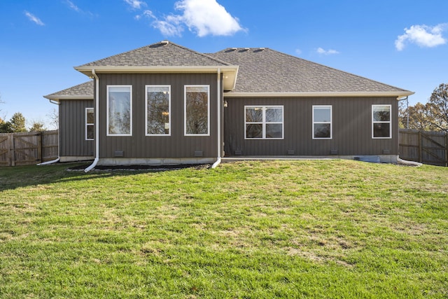 rear view of house featuring a yard