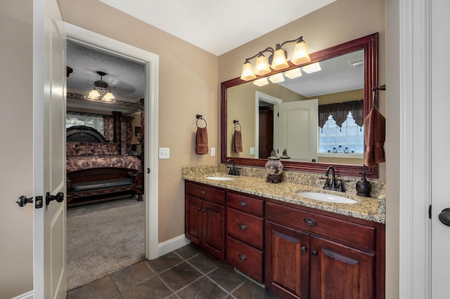 bathroom featuring tile patterned floors, ceiling fan, and vanity