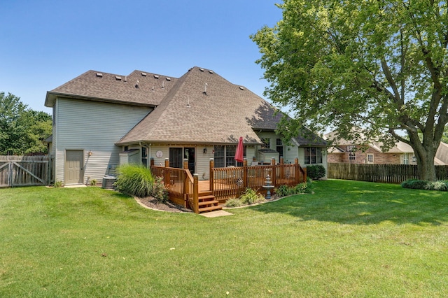 rear view of property with a lawn, central air condition unit, and a deck