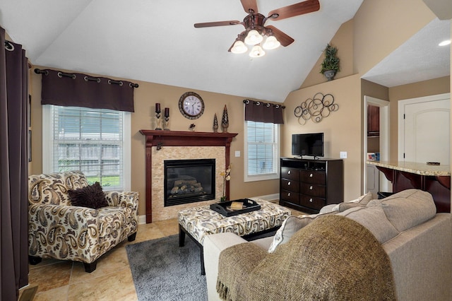 living room with vaulted ceiling, ceiling fan, and a healthy amount of sunlight