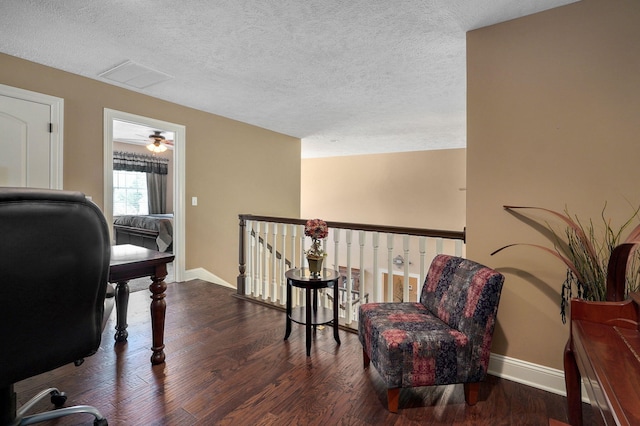 office space with a textured ceiling, dark hardwood / wood-style flooring, and ceiling fan