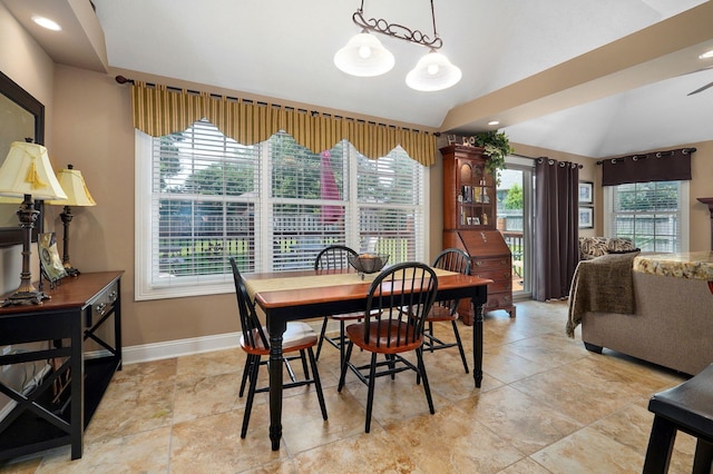 dining area with a chandelier and lofted ceiling