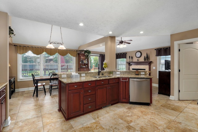 kitchen with pendant lighting, dishwasher, lofted ceiling, and sink