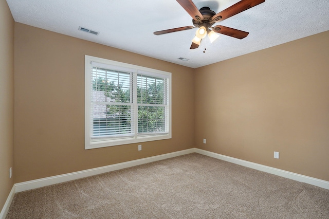 spare room with carpet flooring, a textured ceiling, and ceiling fan