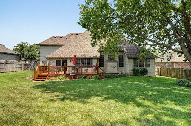 back of property featuring a deck and a lawn