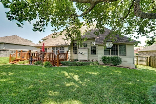 back of house featuring a wooden deck and a yard