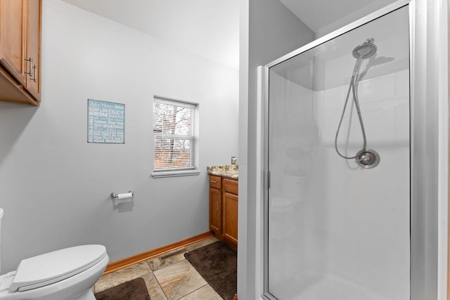 bathroom featuring toilet, vanity, and walk in shower