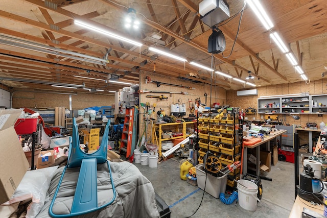 garage featuring a workshop area and a wall unit AC