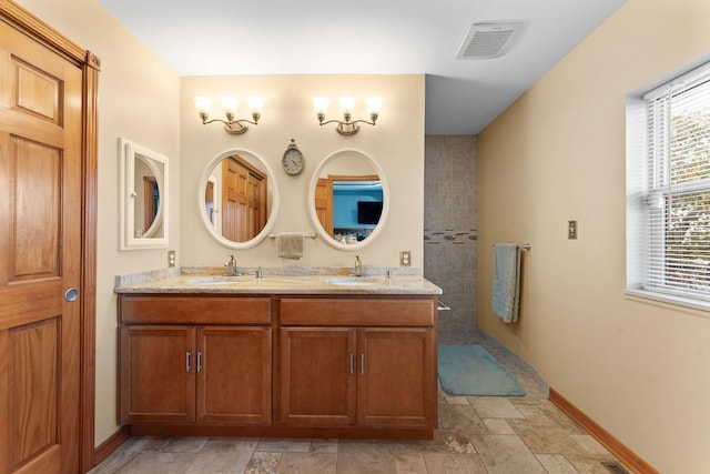 117 Kingdom St, Cape Fair, MO 65624 - full bath with baseboards, stone finish floors, double vanity, and walk in shower