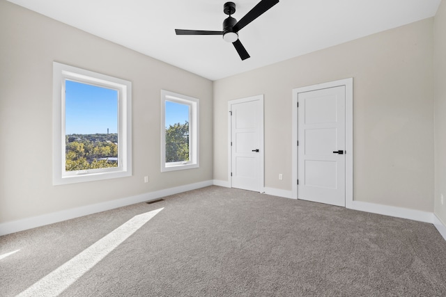 unfurnished bedroom featuring carpet floors and ceiling fan