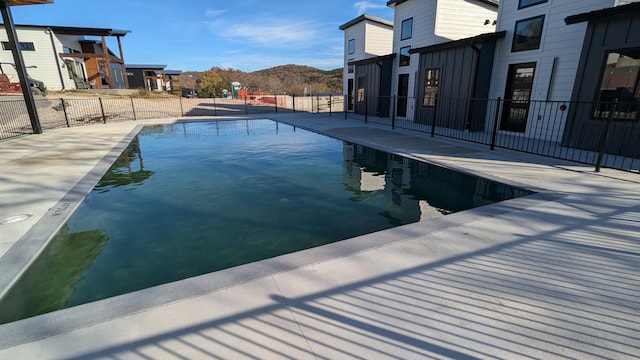 view of swimming pool featuring a patio area and a mountain view