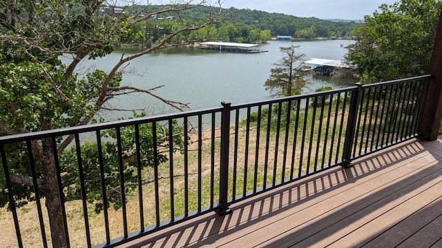 wooden terrace featuring a dock and a water view