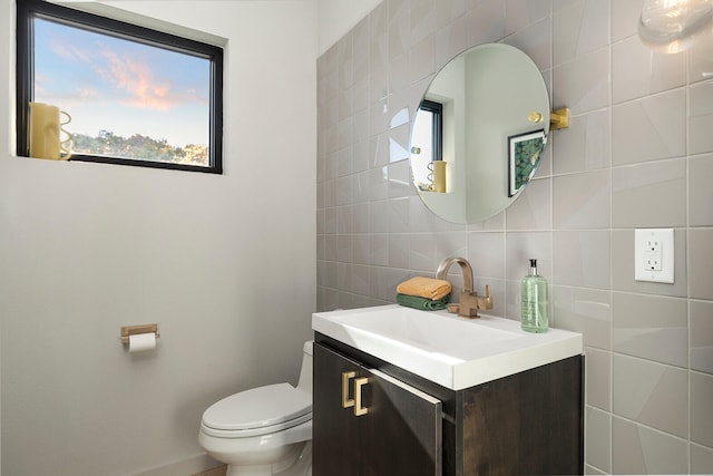 bathroom with backsplash, vanity, tile walls, and toilet