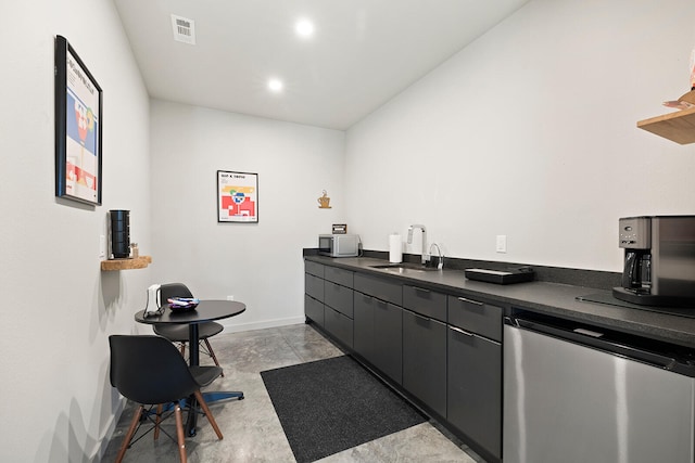 kitchen featuring stainless steel refrigerator and sink