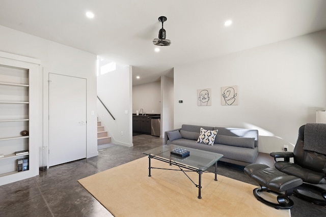 living room with built in shelves and sink