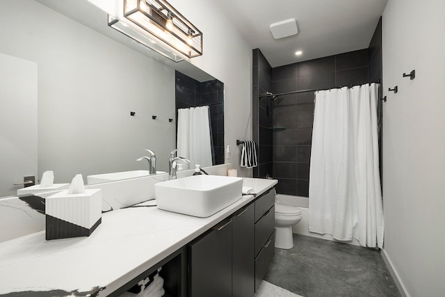 bathroom featuring vanity, concrete flooring, and toilet