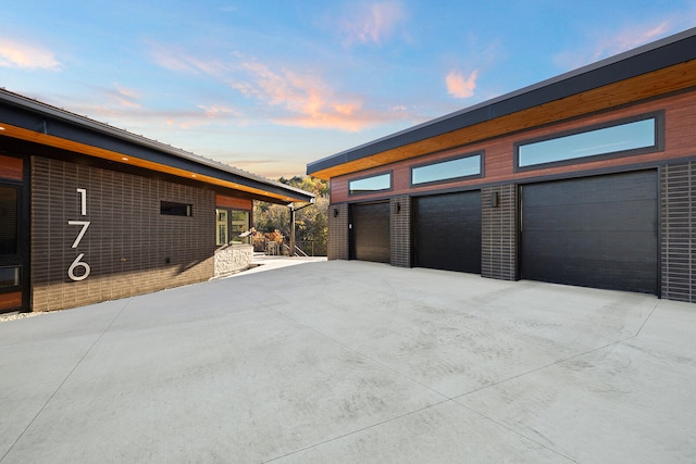 view of garage at dusk