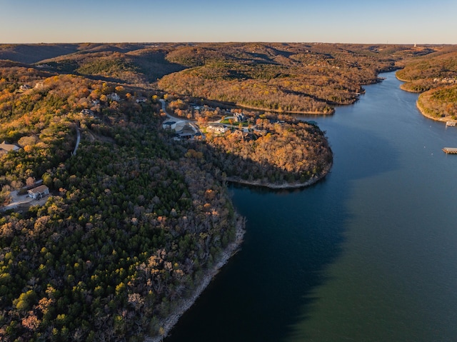 aerial view at dusk featuring a water view