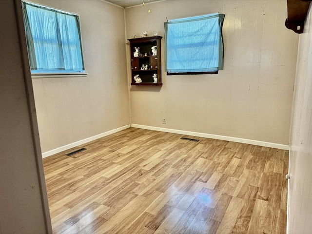 spare room with light hardwood / wood-style flooring