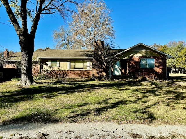 ranch-style home with a front lawn