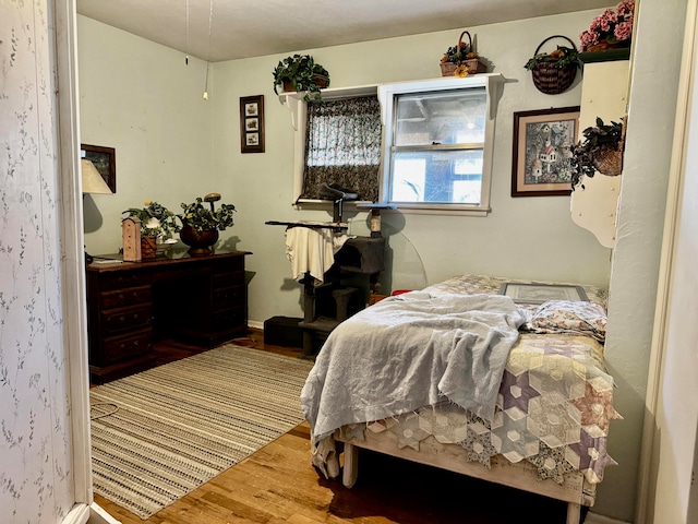 bedroom with hardwood / wood-style floors