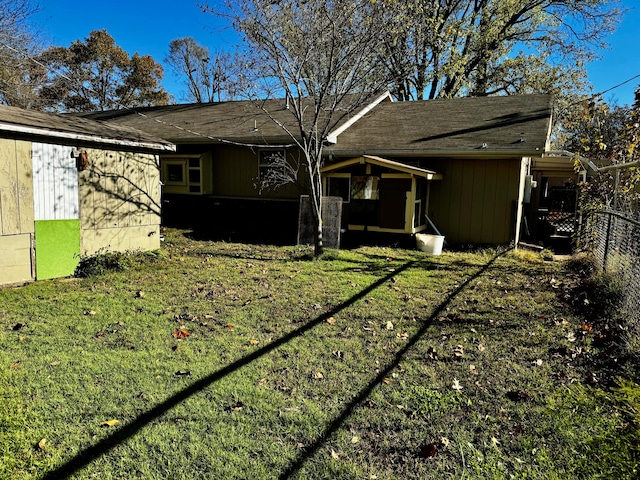 rear view of house with a yard